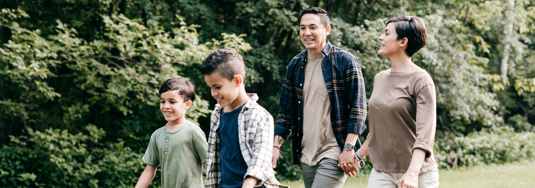 A family of four takes a walk together